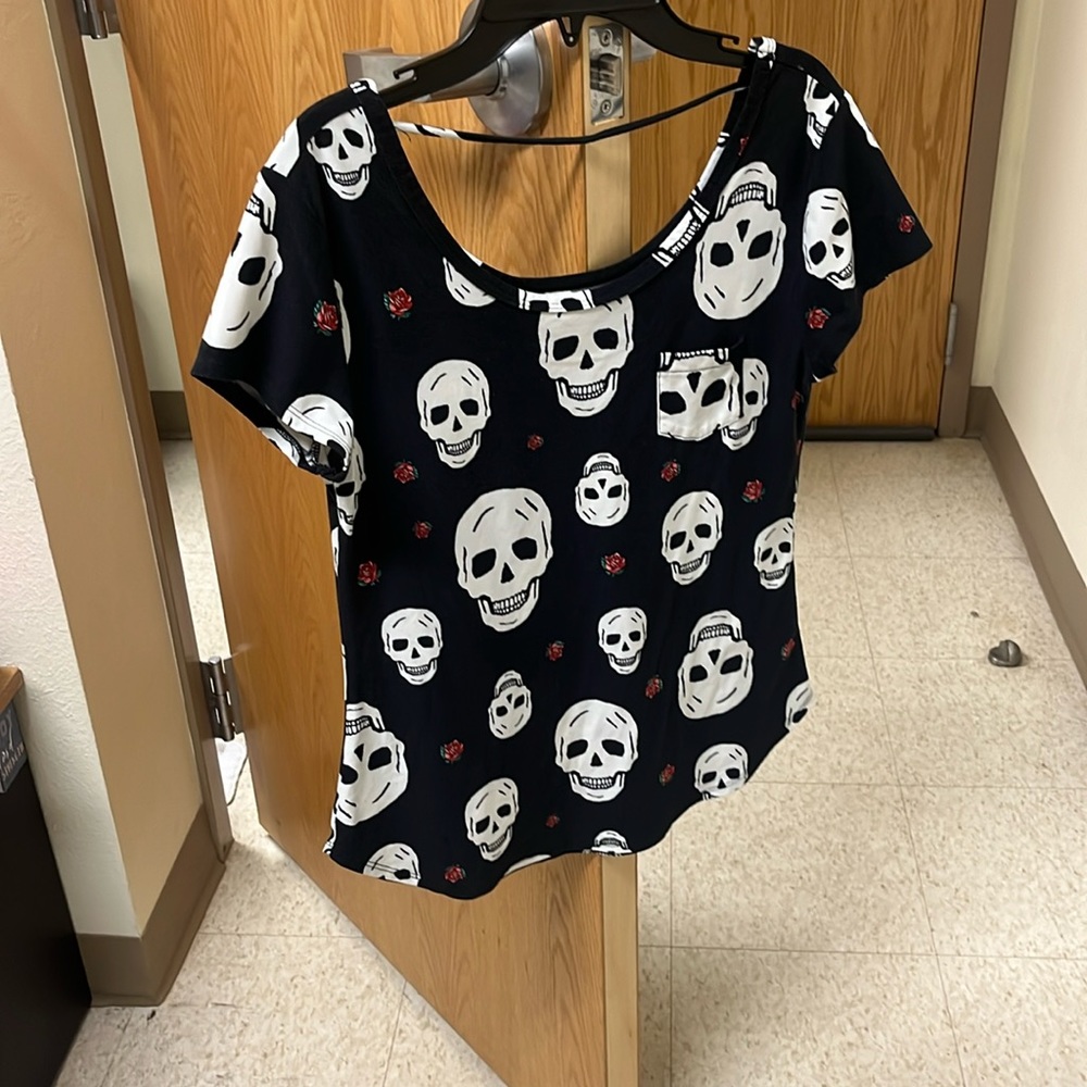 Open upper back top with skeletons and roses design